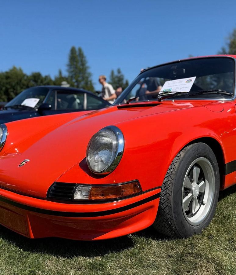 Close-up of a red vintage Porsche 911 on the show field