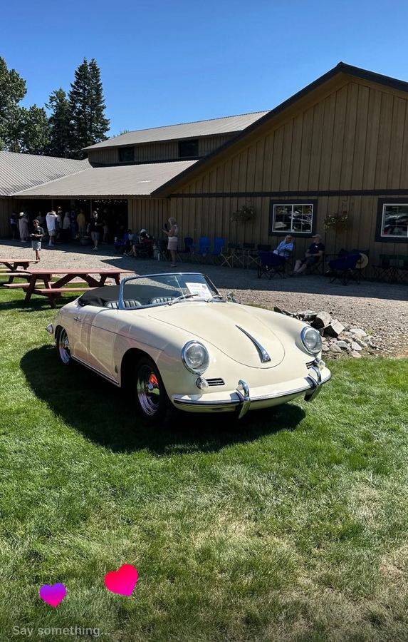 Cream Porsche 356 Speedster on the lawn in front of the barn